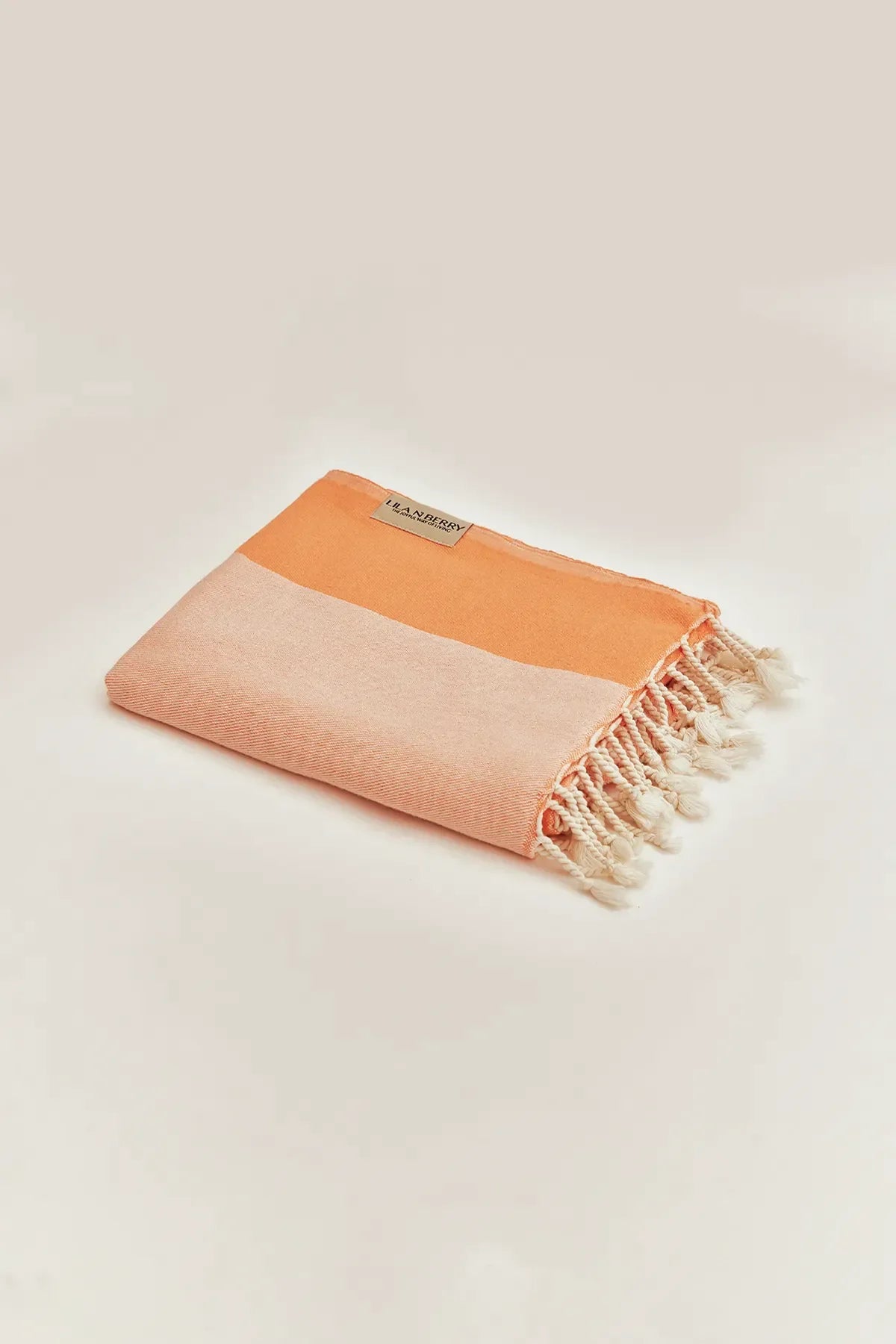 La Luna Peach Turkish Beach Towel by Cove & Fold - folded view