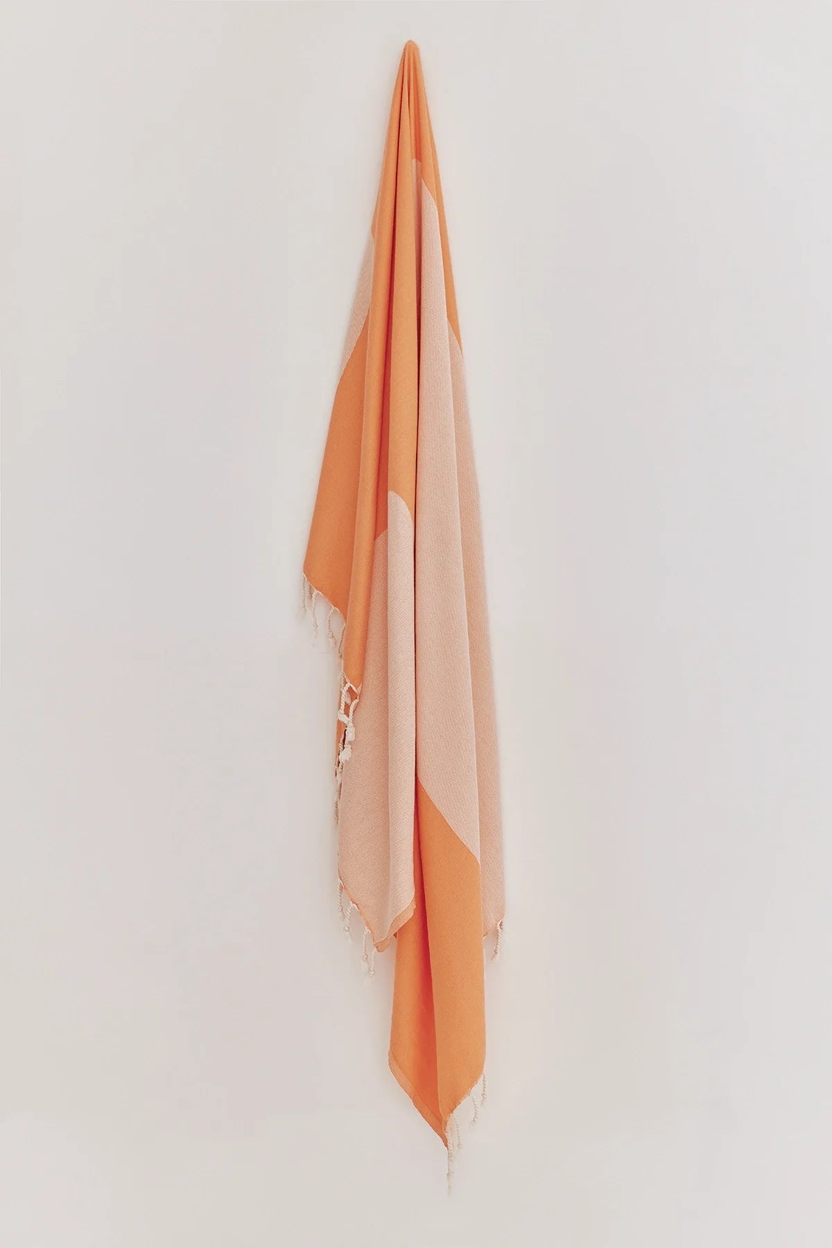La Luna Peach Turkish Beach Towel by Cove & Fold - hanging view